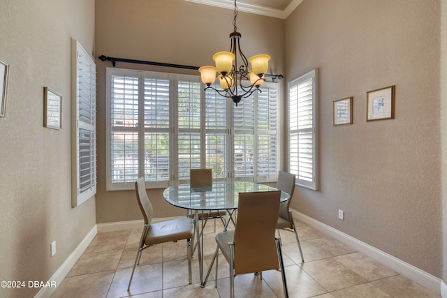 tiled dining room featuring crown molding, plenty of natural light, and a notable chandelier