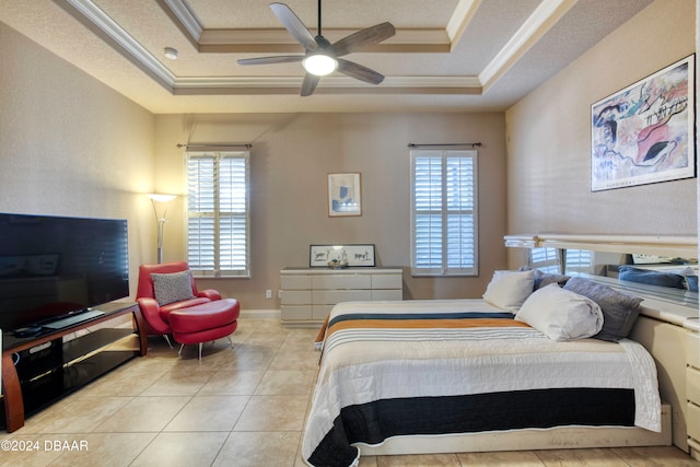 bedroom with a raised ceiling, multiple windows, ornamental molding, and ceiling fan