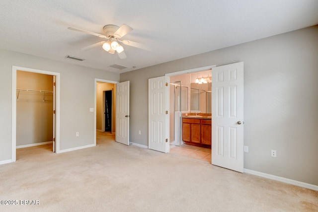 209 Tarracina Way, Daytona Beach, FL 32117 - unfurnished bedroom with visible vents, light carpet, baseboards, a spacious closet, and a sink