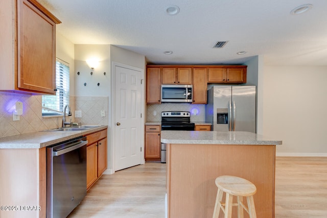 209 Tarracina Way, Daytona Beach, FL 32117 - kitchen with appliances with stainless steel finishes, a sink, visible vents, and light wood-style floors