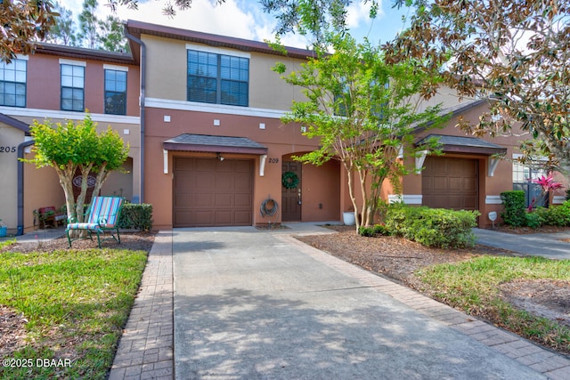 209 Tarracina Way, Daytona Beach, FL 32117 - view of front facade with concrete driveway, an attached garage, and stucco siding