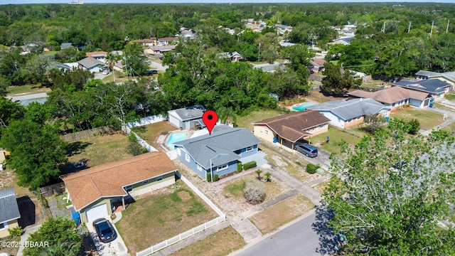 birds eye view of property featuring a forest view and a residential view