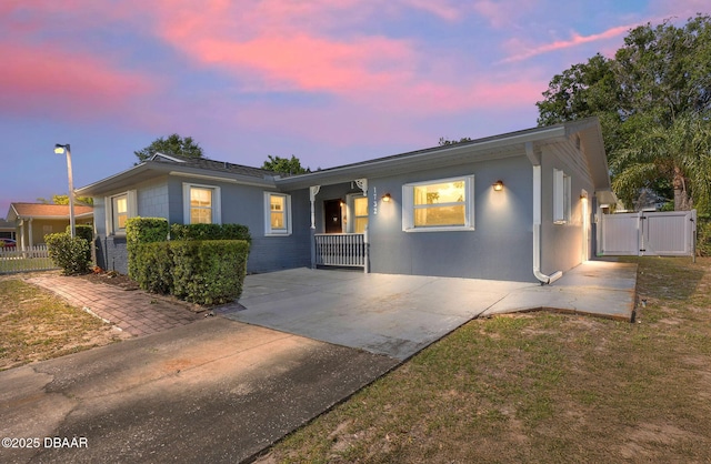ranch-style house featuring a gate and fence