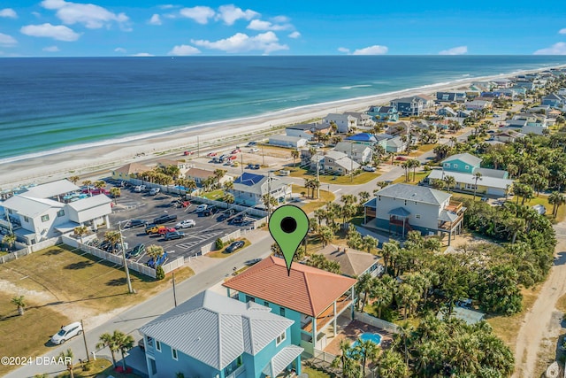 drone / aerial view featuring a water view and a beach view