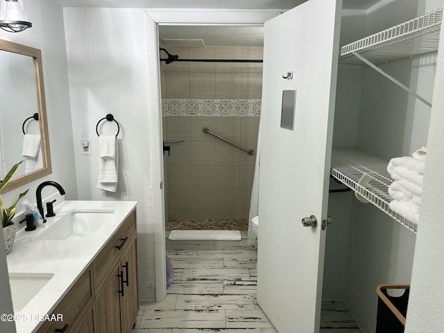 1909 S Atlantic Ave Unit 213, Daytona Beach, FL 32118 - full bath with double vanity, a shower stall, and toilet