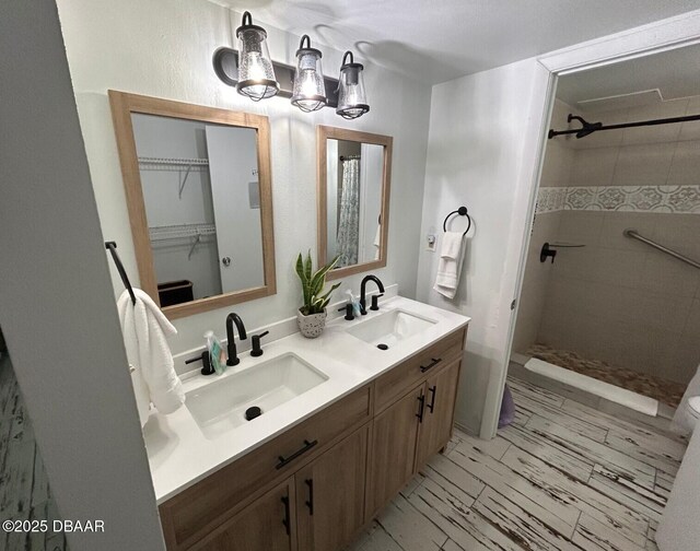1909 S Atlantic Ave Unit 213, Daytona Beach, FL 32118 - full bathroom featuring double vanity, tiled shower, and a chandelier