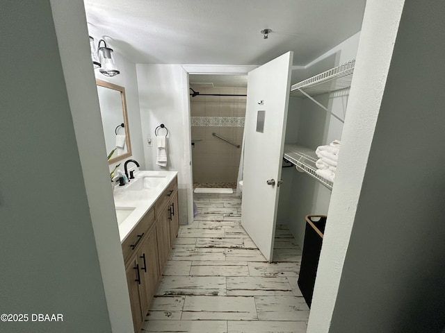 1909 S Atlantic Ave Unit 213, Daytona Beach, FL 32118 - bathroom with a stall shower, double vanity, toilet, and a walk in closet