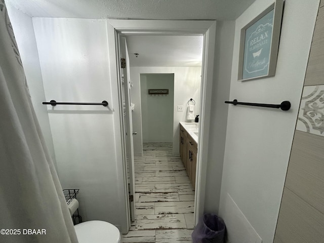 1909 S Atlantic Ave Unit 213, Daytona Beach, FL 32118 - bathroom with marble finish flooring, toilet, and vanity