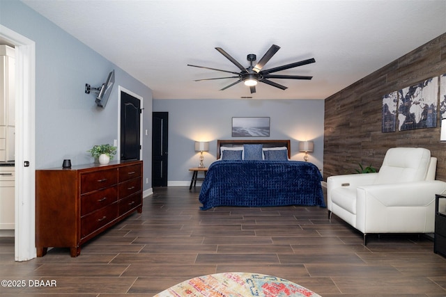 bedroom with wood walls, baseboards, a ceiling fan, and wood tiled floor