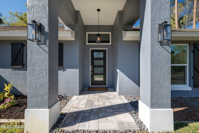 property entrance with stucco siding