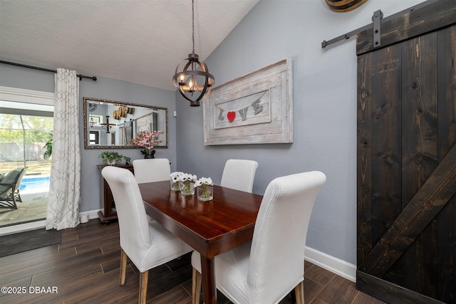 dining space featuring lofted ceiling, baseboards, a chandelier, and wood finish floors