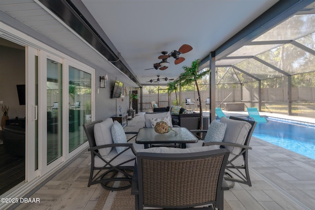 view of patio / terrace featuring glass enclosure, a fenced backyard, a fenced in pool, and a ceiling fan