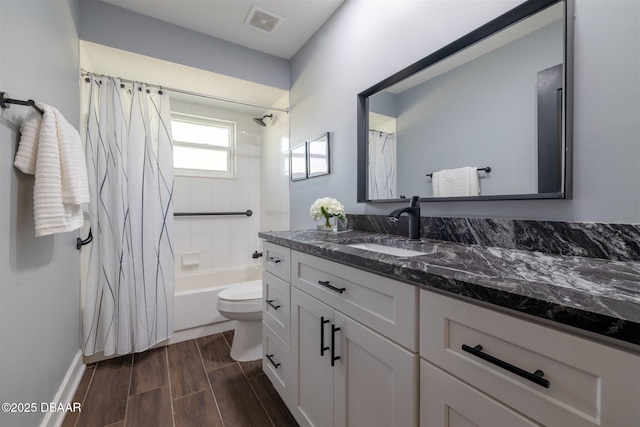 full bathroom with wood finish floors, visible vents, toilet, shower / tub combo with curtain, and vanity