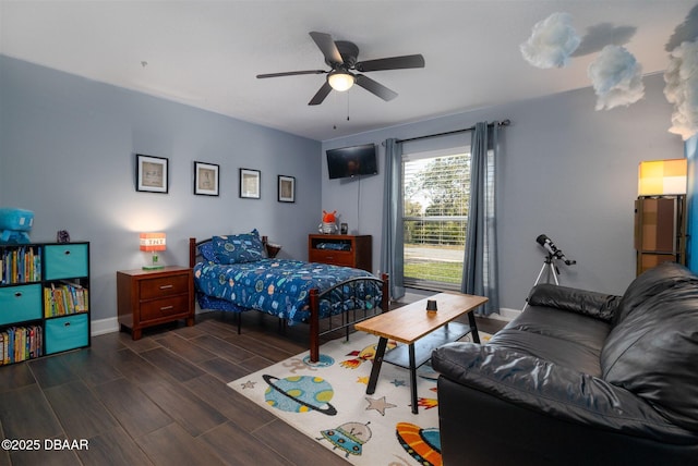 bedroom featuring a ceiling fan, baseboards, and wood tiled floor