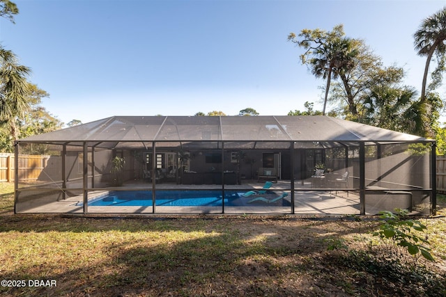 view of pool with a patio area, a fenced in pool, glass enclosure, and fence