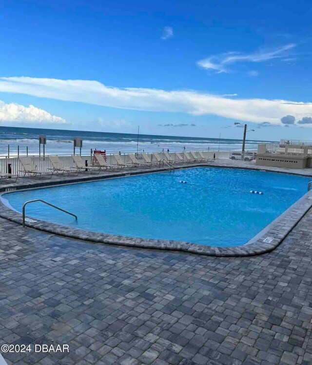 view of swimming pool with a water view