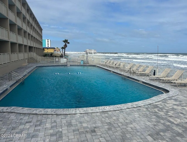 view of swimming pool featuring a water view