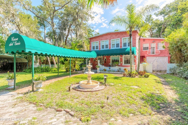 back of property featuring a yard and a carport