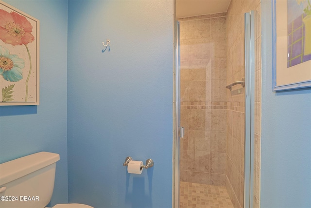 bathroom with walk in shower and toilet