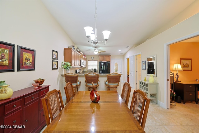 tiled dining space featuring ceiling fan with notable chandelier