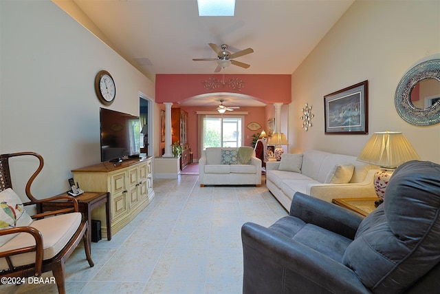 living room featuring decorative columns, ceiling fan, and lofted ceiling