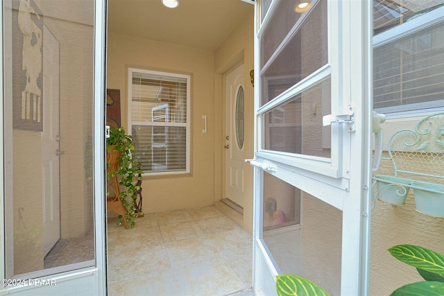 entrance to property featuring a patio area