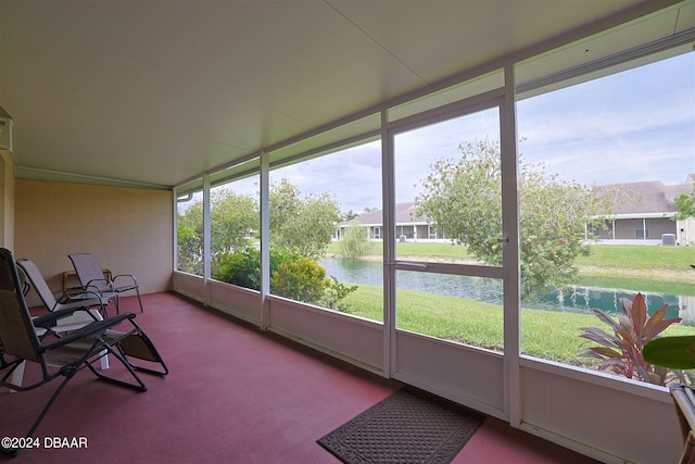 sunroom with a water view and a wealth of natural light