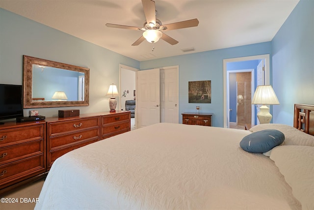 bedroom featuring a closet, ceiling fan, and ensuite bathroom