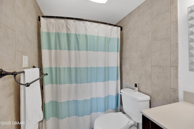 2947 S Atlantic Ave Unit 601, Daytona Beach, FL 32118 - bathroom with tile walls, vanity, and curtained shower