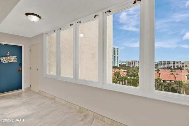 2947 S Atlantic Ave Unit 601, Daytona Beach, FL 32118 - unfurnished sunroom with healthy amount of natural light and a view of city