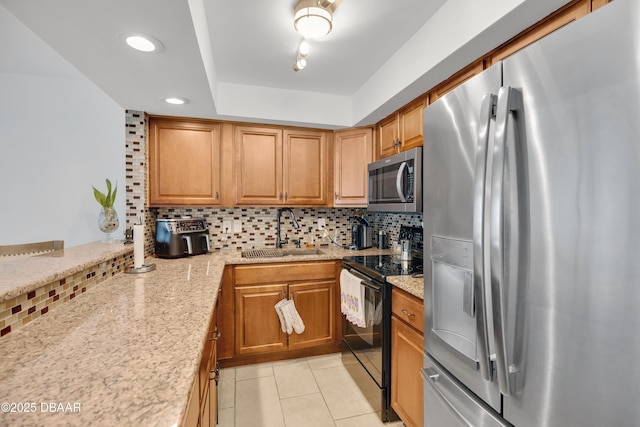 2947 S Atlantic Ave Unit 601, Daytona Beach, FL 32118 - kitchen with stainless steel appliances, decorative backsplash, light tile patterned flooring, light stone countertops, and a tray ceiling
