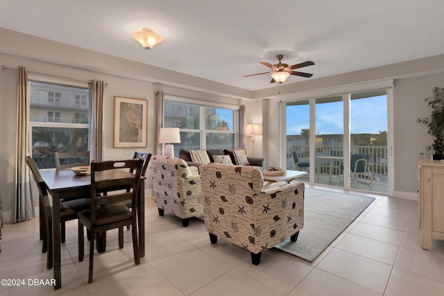 living room with light tile patterned floors and ceiling fan