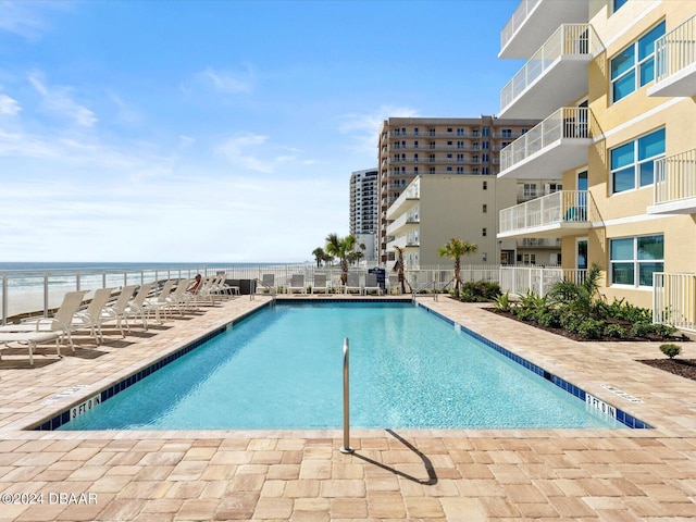 view of pool with a water view