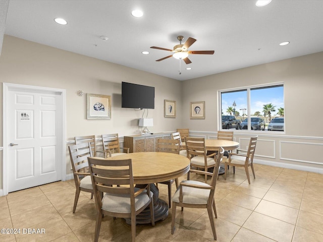 tiled dining space with ceiling fan