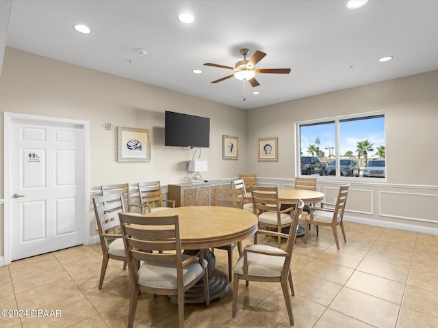 3721 S Atlantic Ave Unit 207, Daytona Beach Shores, FL 32118 - dining room featuring a ceiling fan, recessed lighting, light tile patterned floors, a decorative wall, and a wainscoted wall