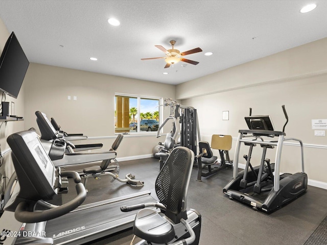 exercise area with a textured ceiling and ceiling fan