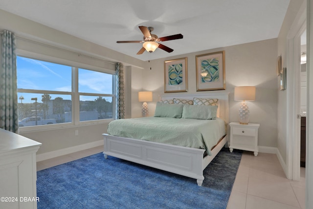 bedroom with ceiling fan and tile patterned floors