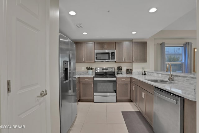 3721 S Atlantic Ave Unit 207, Daytona Beach Shores, FL 32118 - kitchen with stainless steel appliances, light tile patterned floors, light stone counters, and recessed lighting