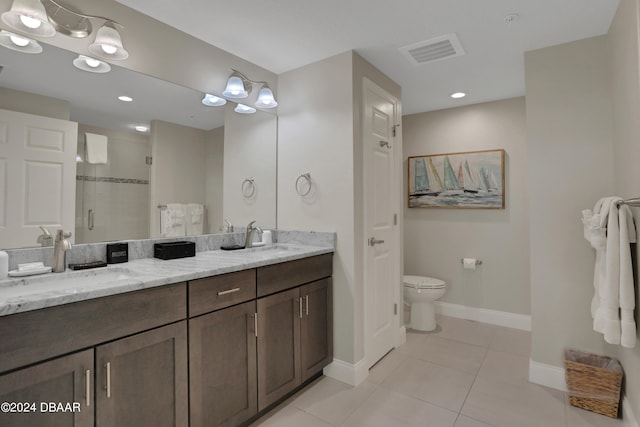 bathroom featuring vanity, walk in shower, tile patterned flooring, and toilet