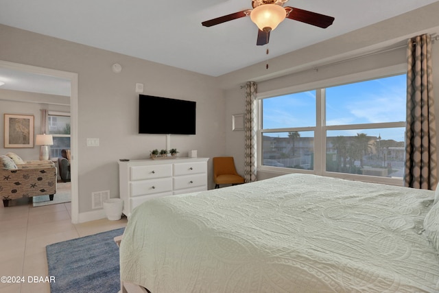 bedroom featuring light tile patterned flooring and ceiling fan