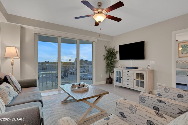 tiled living room featuring ceiling fan