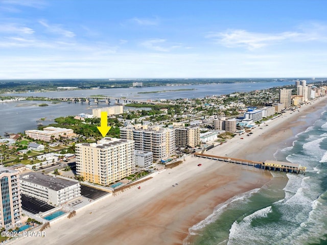 drone / aerial view featuring a beach view and a water view