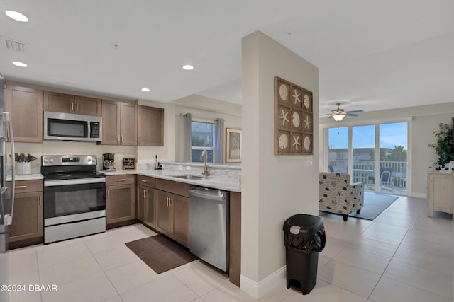 3721 S Atlantic Ave Unit 207, Daytona Beach Shores, FL 32118 - kitchen with appliances with stainless steel finishes, light tile patterned flooring, recessed lighting, a ceiling fan, and open floor plan