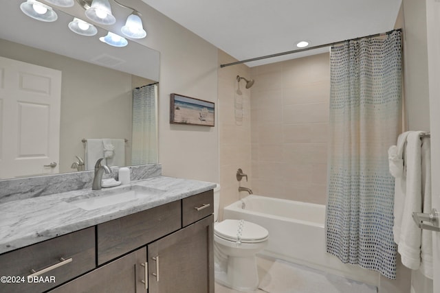 full bathroom featuring shower / tub combo with curtain, vanity, and toilet