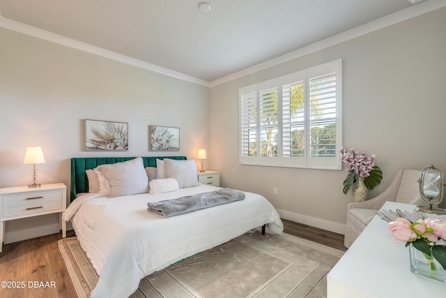 bedroom featuring light hardwood / wood-style floors and crown molding