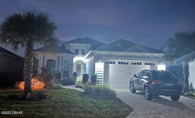 view of front of house with a garage and a front yard