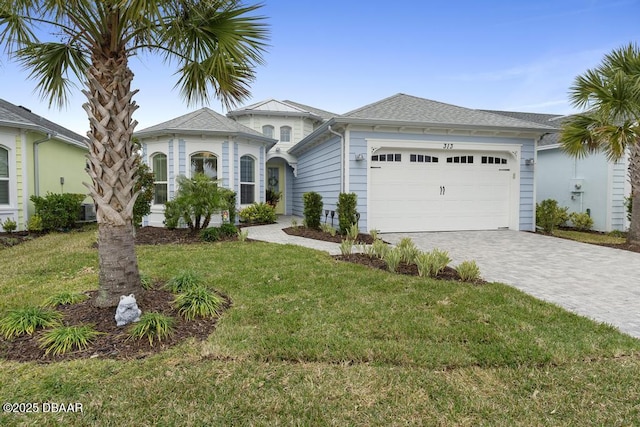 view of front facade featuring a garage and a front lawn