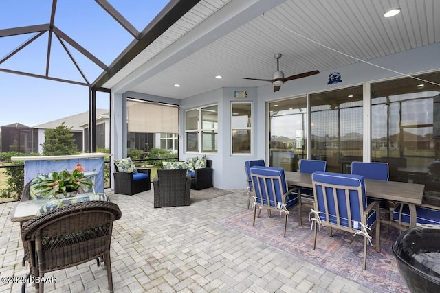 view of patio / terrace with ceiling fan, outdoor lounge area, and glass enclosure