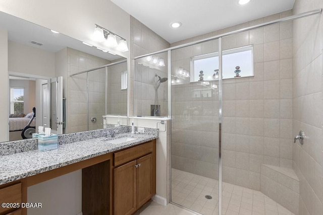 bathroom featuring vanity, plenty of natural light, and an enclosed shower