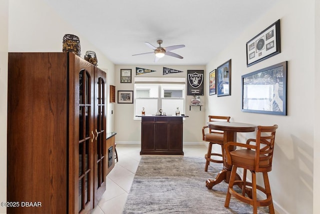 bar with ceiling fan and light tile patterned flooring